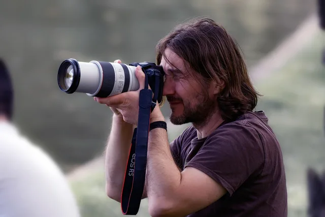 man, photographer, outdoors, dslr, park, telephoto, taking pictures, taking photos. Photography Rush Order Policy: Steps, Timing and Refunds
