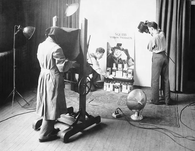 The Peake & Whittingham photography studio at 159 Elm Street, just west of University Avenue in Toronto, Ontario, Canada. The studio interior shows W. J. (Bill) Whittinham behind the camera, while his son, Ted, arranges the shot of Squibb Vitamin products. A local SEO checklist photography studios can finish in a day